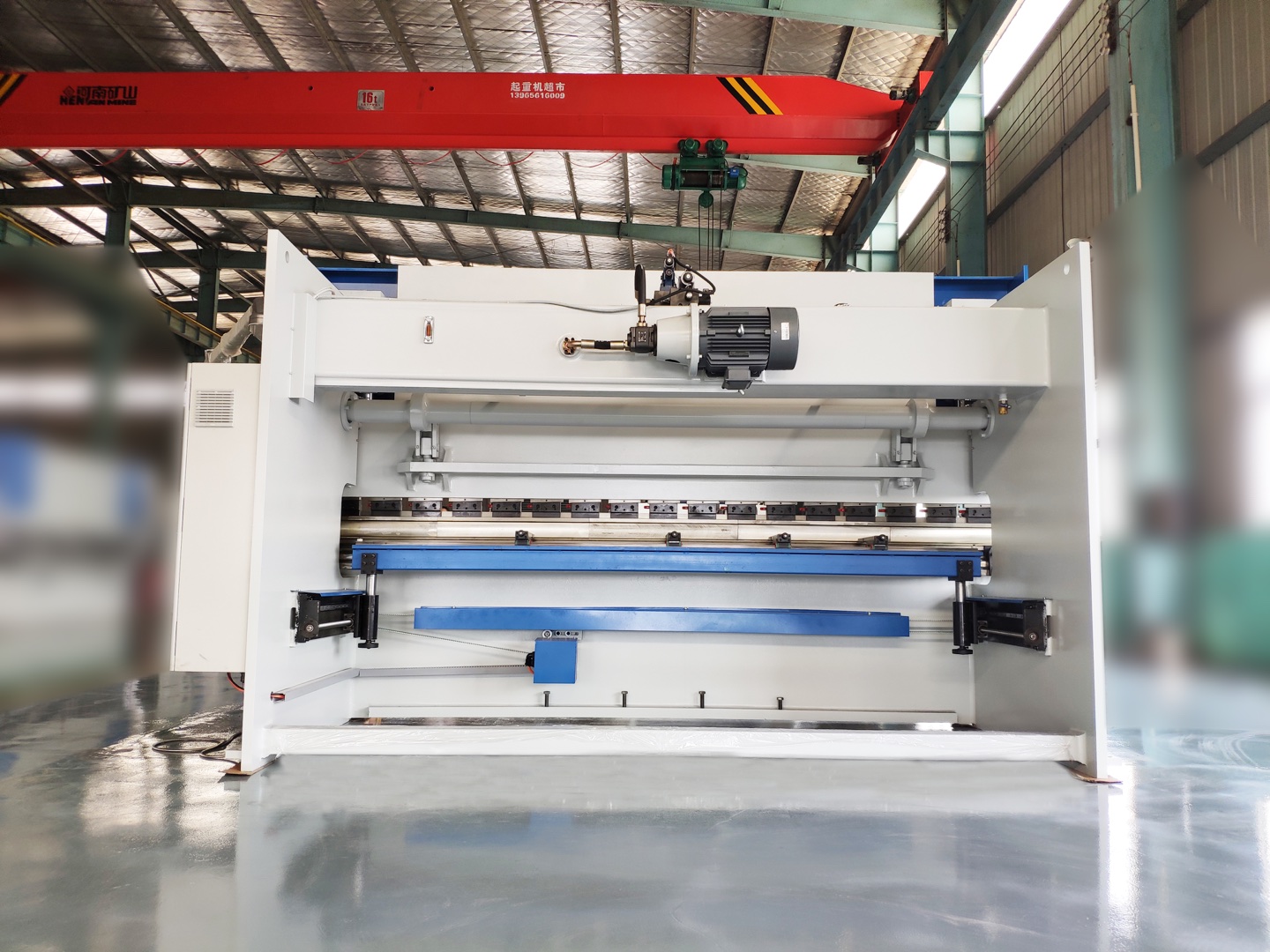 Rear view of an NC hydraulic press brake showing its drive and back gauge arrangement.
