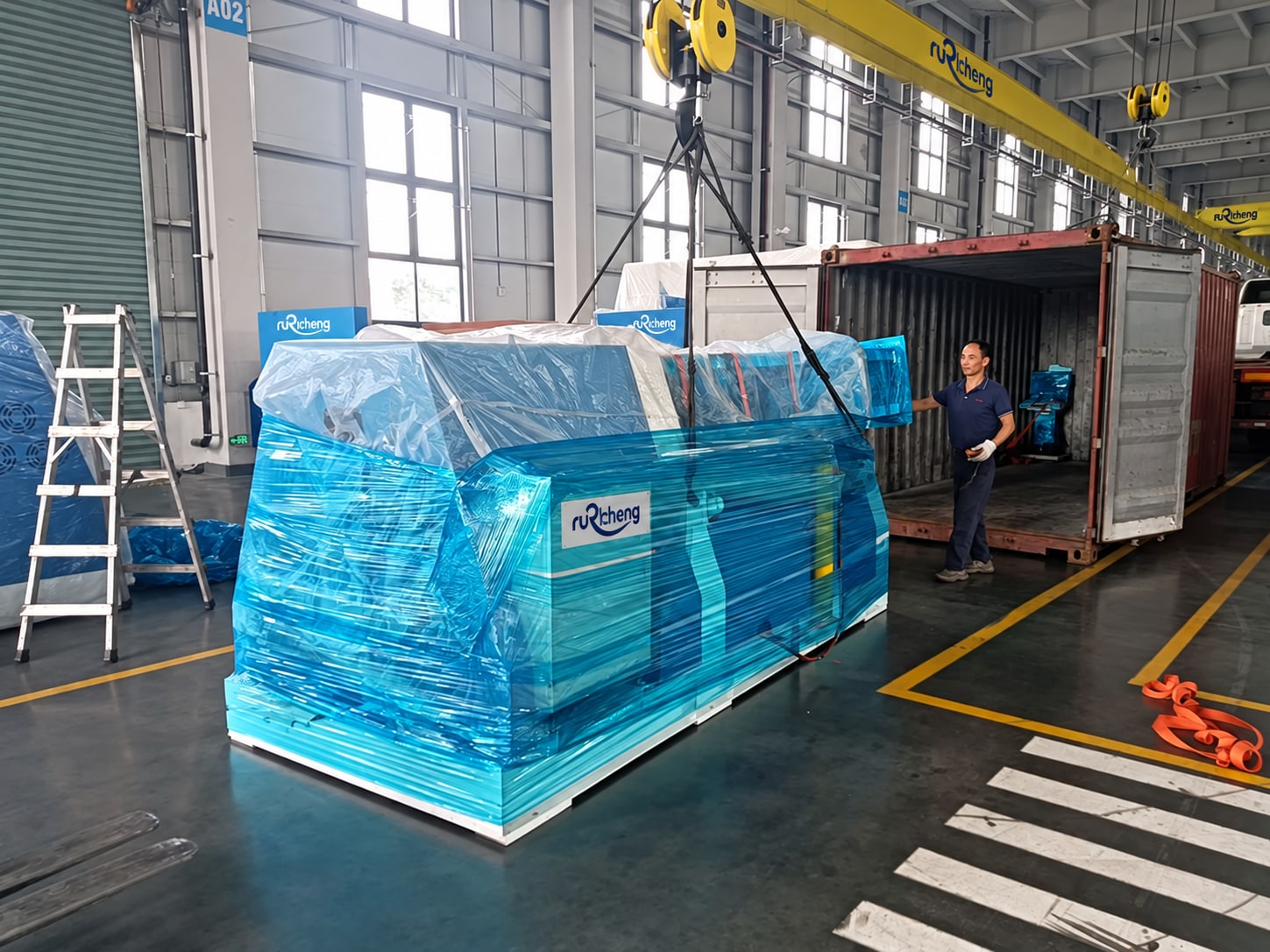 Wrapped rolling equipment beside the container; visible manufacturer marks adapted to Rucheng.