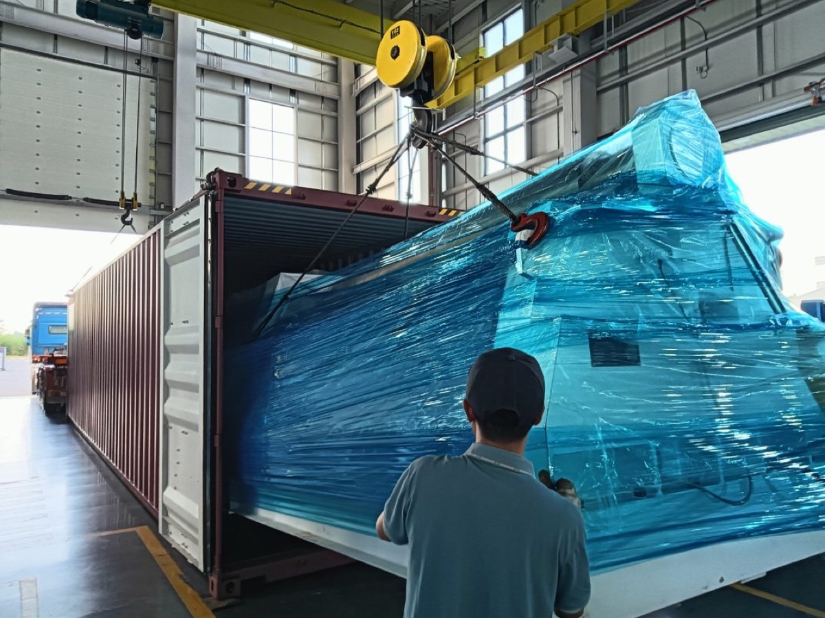 Protected equipment being lifted during container loading.