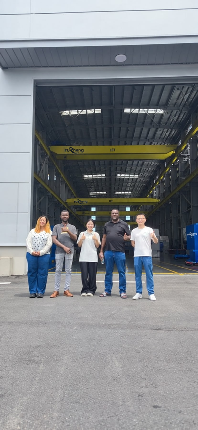 Visitors at the workshop entrance; visible crane branding adapted to Rucheng.